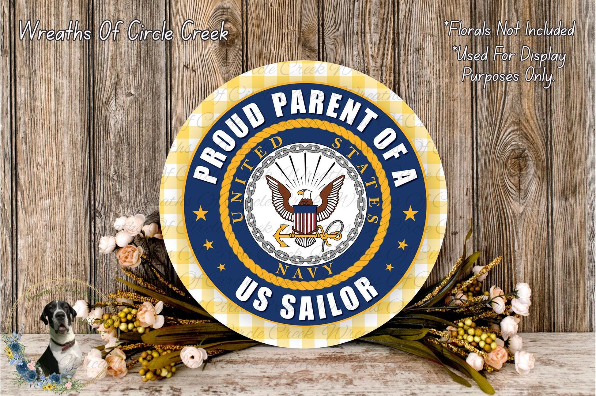 a patriotic symbol of the United States Navy, surrounded by flowers and a wooden background.
