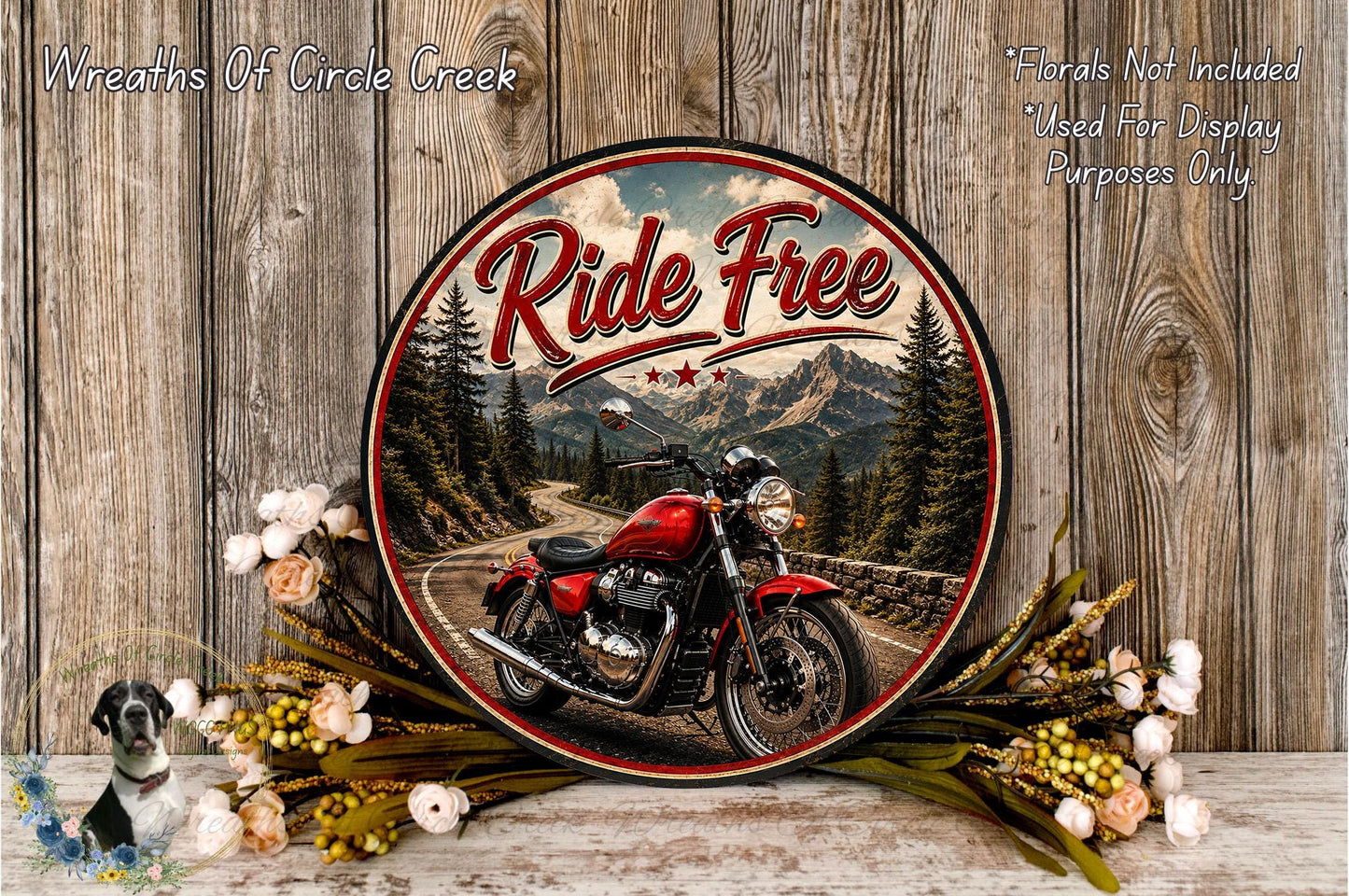 a red motorcycle on a road surrounded by a wreath of flowers and a wooden wall.