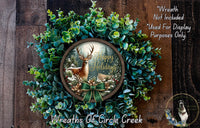 A wreath made of green foliage and a deer image, with the text "Happy Holidays" displayed on it.