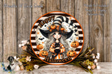 A Halloween-themed plate with a cartoon illustration of a young girl wearing a witch's hat and holding a black cat, surrounded by pumpkins and flowers.