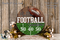 A wooden sign with the text "Hello Football Season" and a football graphic, surrounded by a floral arrangement and a wooden background.
