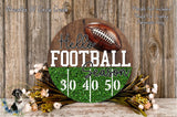 A wooden sign with the text "Hello Football Season" and a football graphic, surrounded by a floral arrangement and a wooden background.