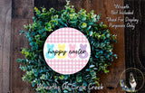 a wreath made of green leaves and flowers, with a pink and white checkered border and the text "happiness easter" displayed on it.