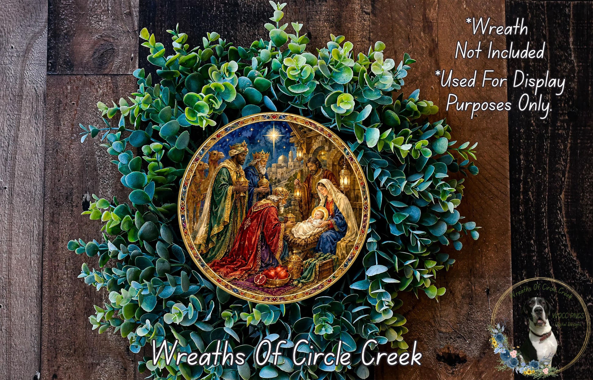 A wreath with a painting of the Nativity scene, surrounded by greenery, and a dog in the corner.