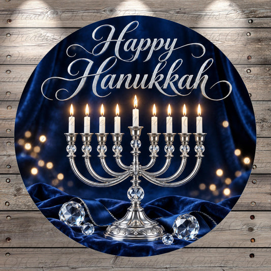 A round blue banner with a silver candelabra and lit candles, surrounded by sparkling lights and crystals, with the text "Happy Hanukkah" displayed prominently.