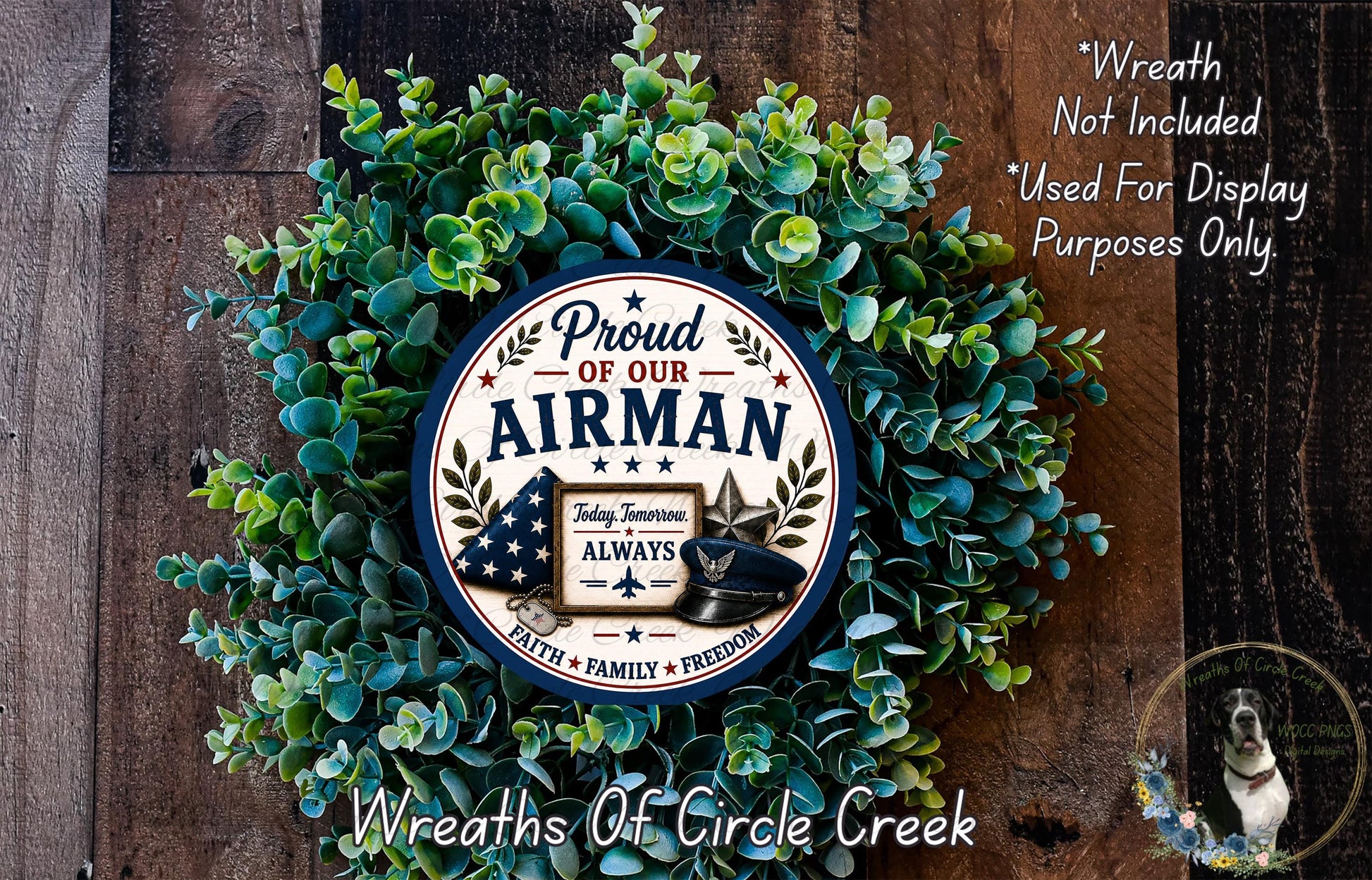 A wreath made of green leaves and a circular sign with patriotic symbols, including an American flag and a bald eagle, is displayed on a wooden surface.