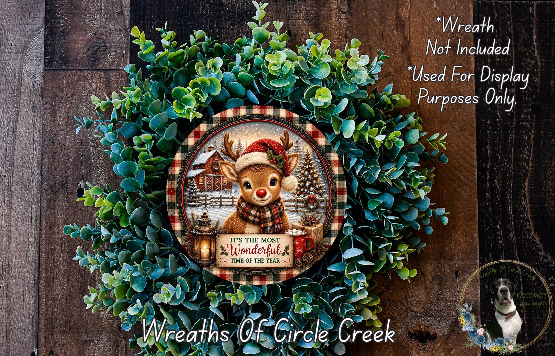 A wreath made of green foliage and featuring a deer wearing a Santa hat, with a sign that reads "It's the most wonderful time of the year".