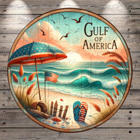 A circular wooden sign with a beach scene, featuring an American flag, a beach umbrella, and a pair of flip-flops, with a sunset and waves in the background.