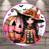 A whimsical illustration of a young girl wearing a witch's hat and sitting next to a large, intricately designed pumpkin. The pumpkin has a patchwork design and is surrounded by bats and other Halloween-themed elements. The girl is wearing striped boots and a scarf, and she has a big smile on her face.