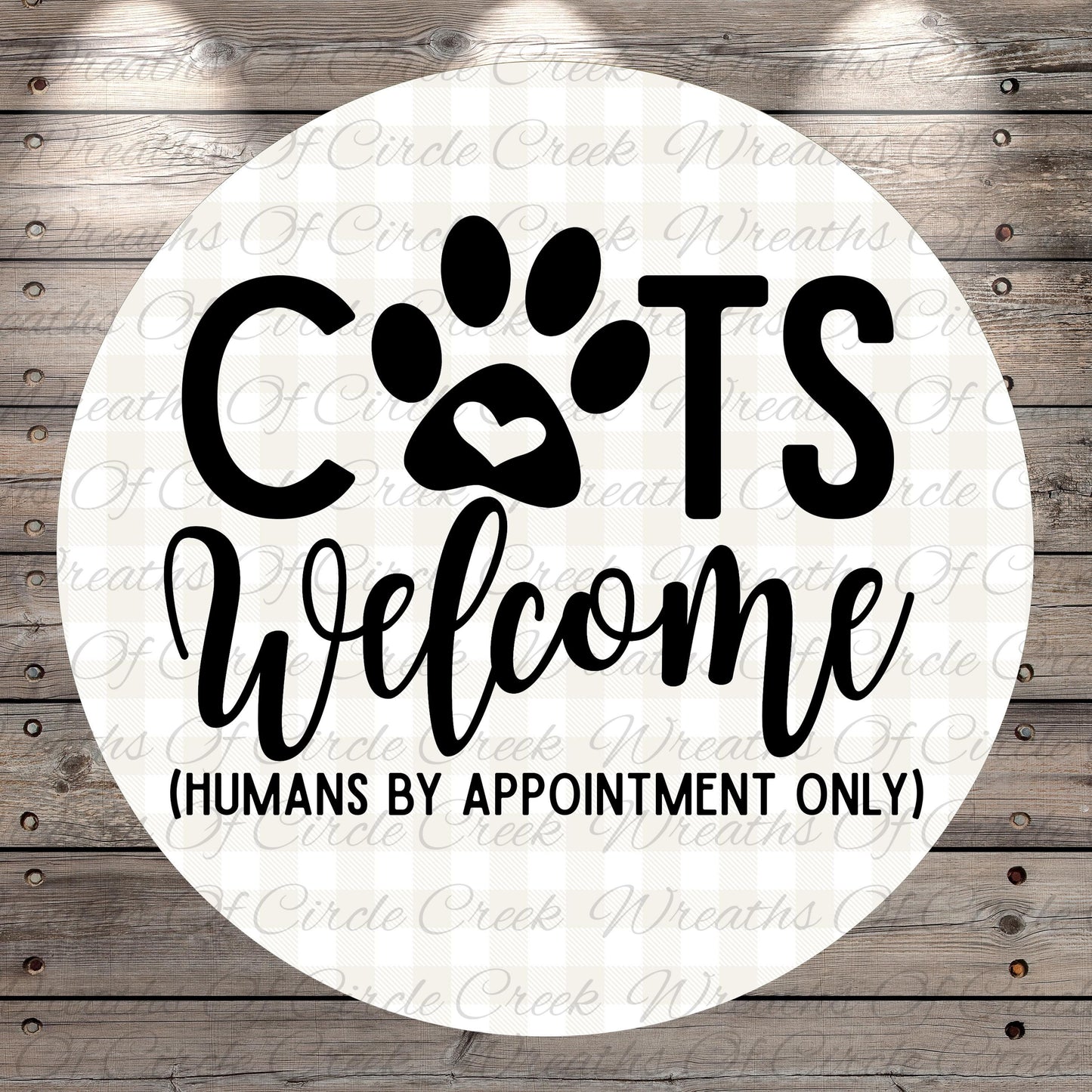 a circular sign with the text "CATS Welcome (HUMANS BY APPOINTMENT ONLY)" written on it.
