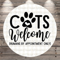 a circular sign with the text "CATS Welcome (HUMANS BY APPOINTMENT ONLY)" written on it.