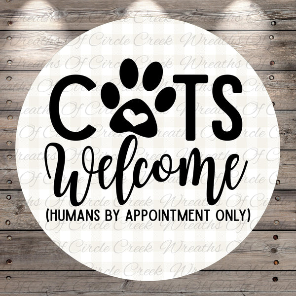 a circular sign with the text "CATS Welcome (HUMANS BY APPOINTMENT ONLY)" written on it.