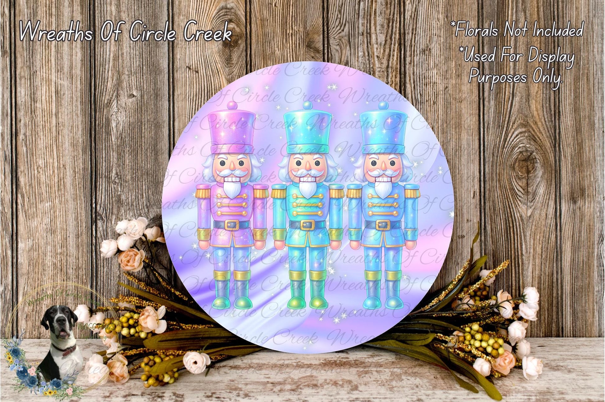three nutcracker soldiers in different colored uniforms, standing in a row and surrounded by a wreath of flowers and greenery.