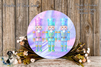 three nutcracker soldiers in different colored uniforms, standing in a row and surrounded by a wreath of flowers and greenery.
