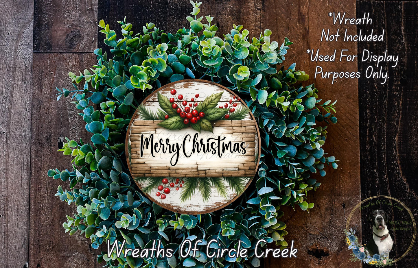 A wreath made of various green plants and red berries, with a wooden sign that says "Merry Christmas" in the center. The wreath is displayed on a wooden surface, and there is a text overlay that reads "Wreath Not Included * Used For Display Purposes Only".