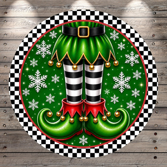 A festive Christmas-themed image featuring a pair of green elf boots with black and white striped legs, red tassels, and gold bells, surrounded by snowflakes and a black and white checkered border.