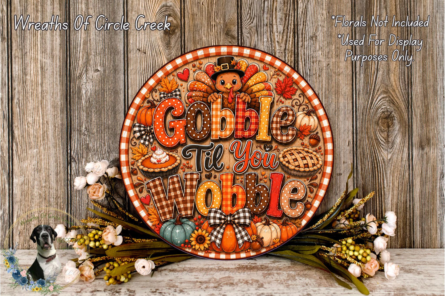 A decorative Thanksgiving wreath with the text "Gobble Till You Gobble" displayed on it, surrounded by fall-themed elements such as pumpkins, gourds, and flowers.