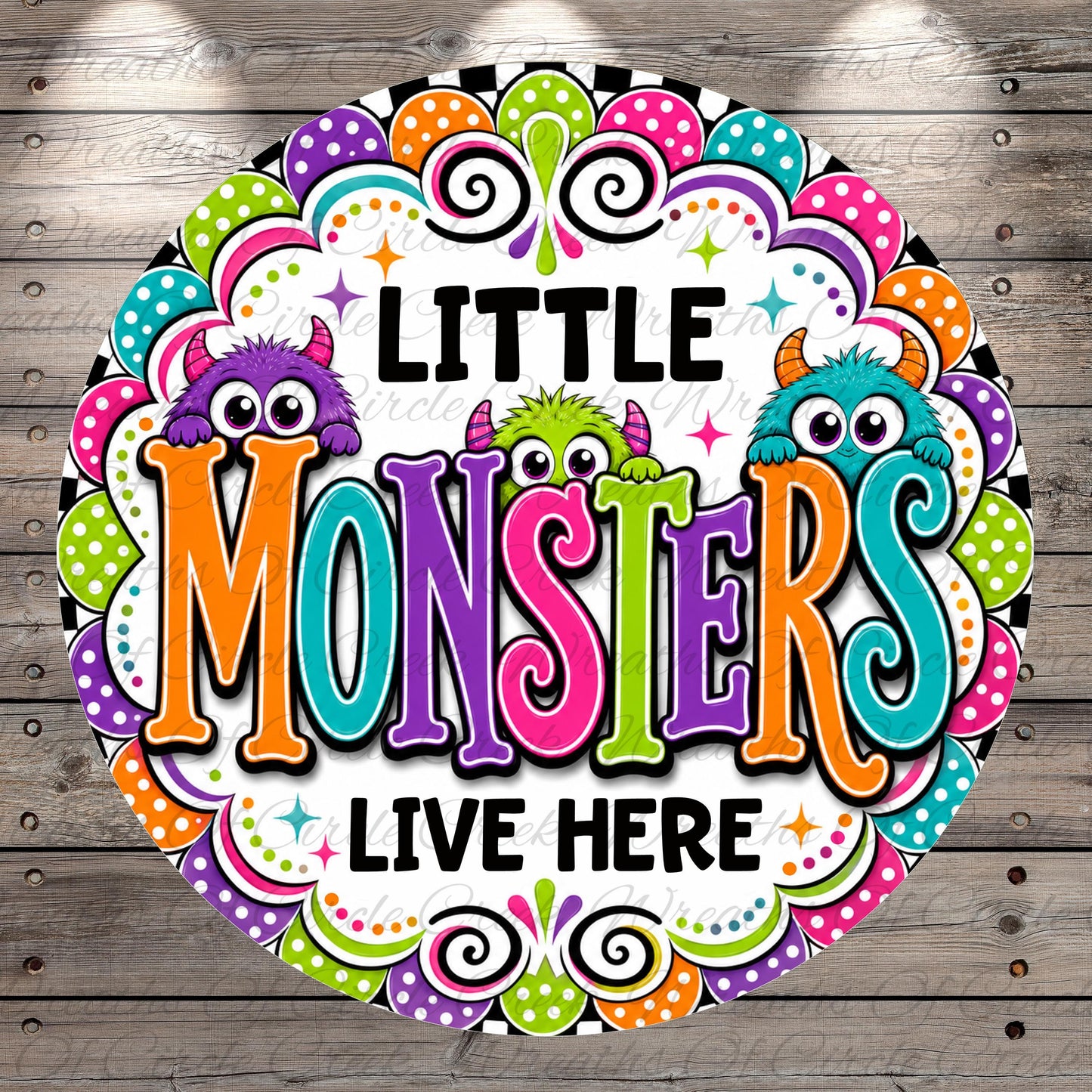a colorful and whimsical design with the text "LITTLE MONSTERS LIVE HERE" surrounded by various monster-themed elements such as polka dots, stars, and swirls.