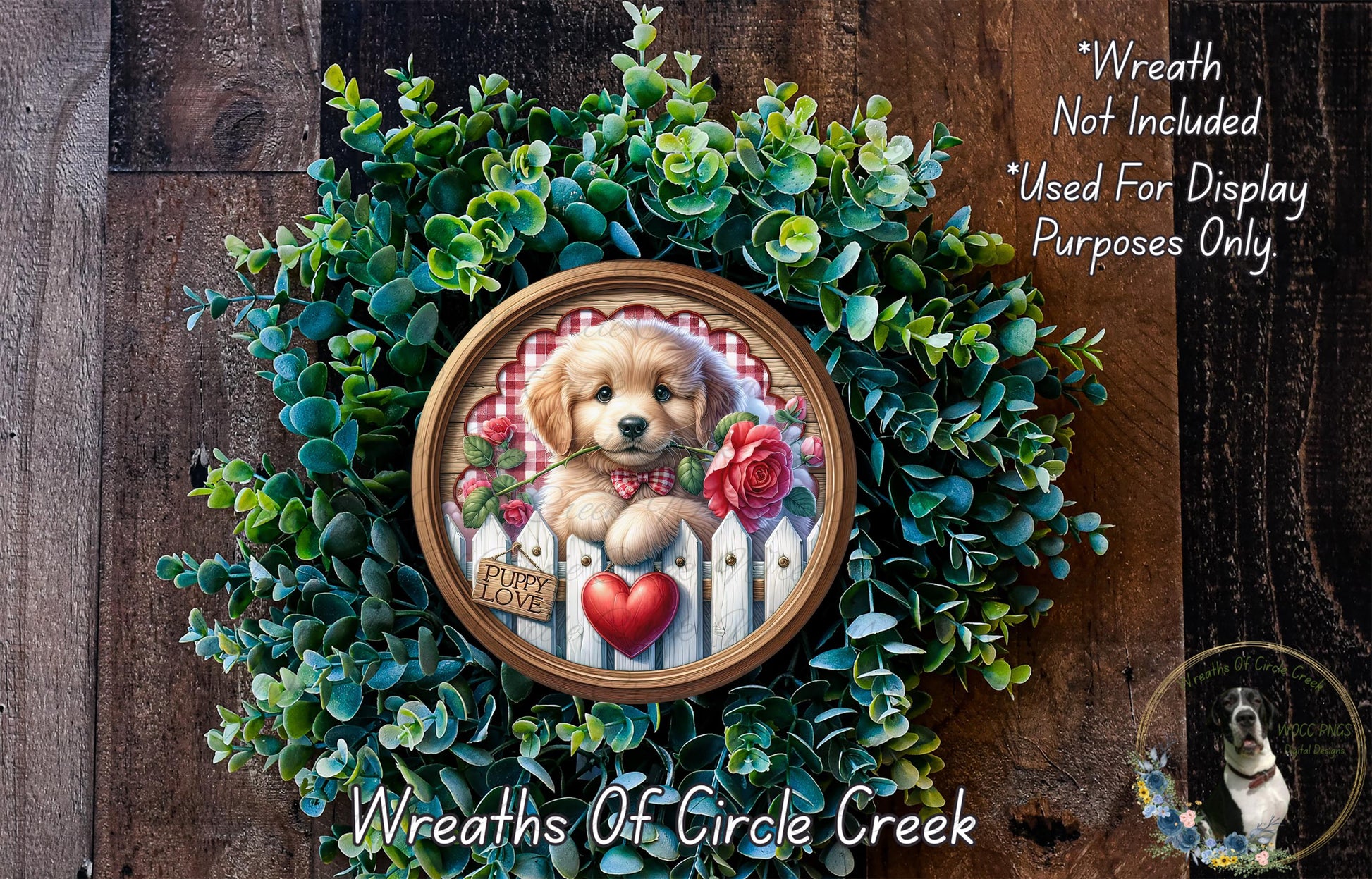 A wreath with a golden retriever puppy wearing a red bow tie and holding a red rose, surrounded by green foliage.
