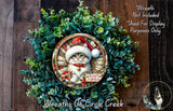 A wreath featuring a cat wearing a Santa hat, surrounded by greenery, with a sign that says "Merry Pawsas" and a smaller image of a dog in the bottom right corner.