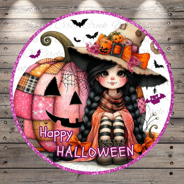 A young girl with long black hair and a witch's hat sits next to a large patchwork pumpkin, surrounded by bats and other Halloween decorations. The text "Happy Halloween" is displayed in the image.