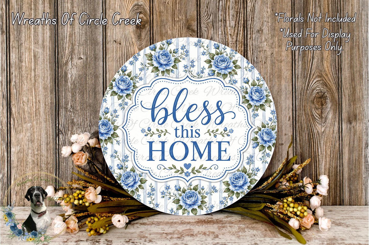 A round wooden sign with a floral design and the text "bless this home" is displayed against a wooden background.