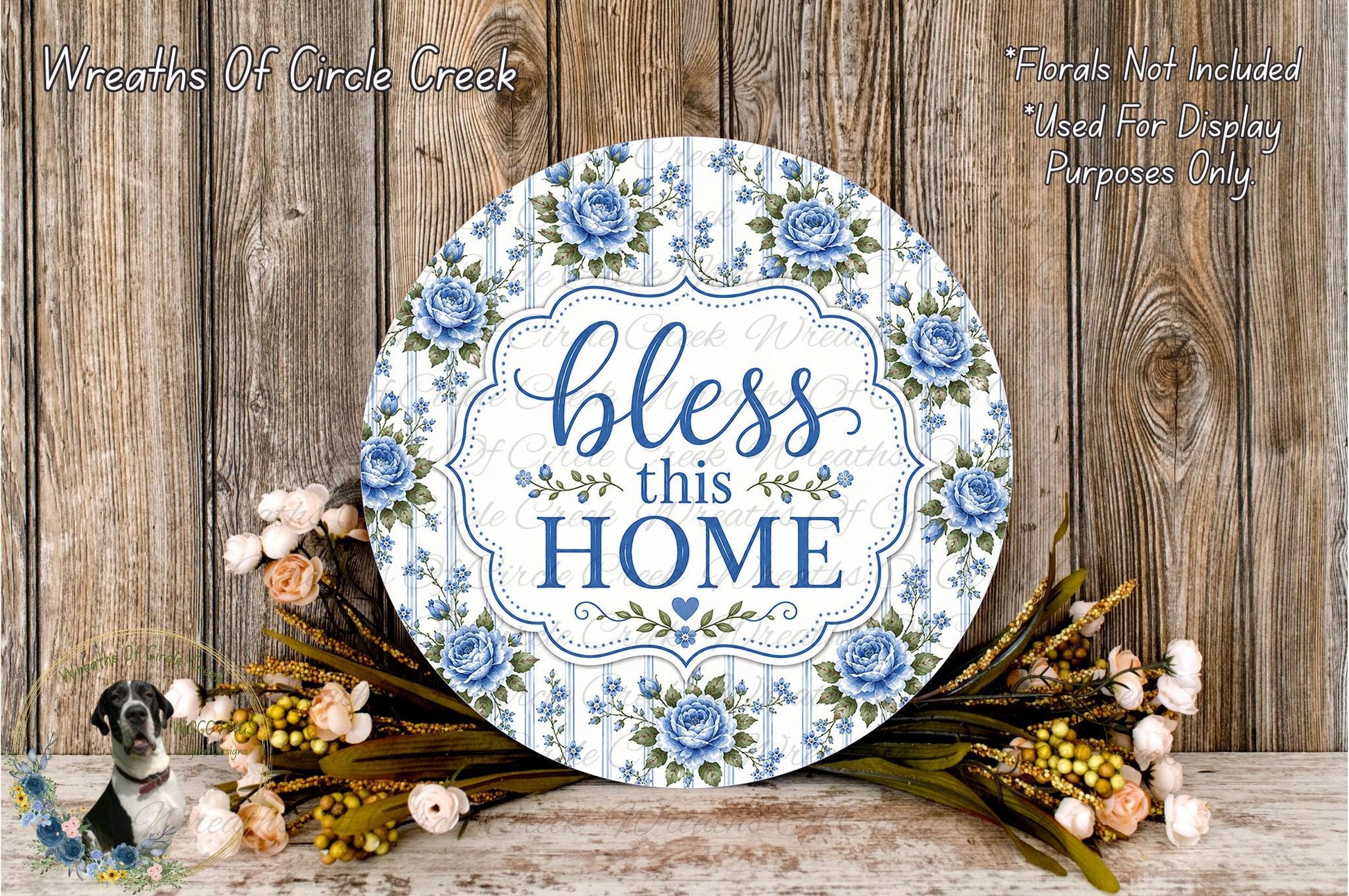 A round wooden sign with a floral design and the text "bless this home" is displayed against a wooden background.