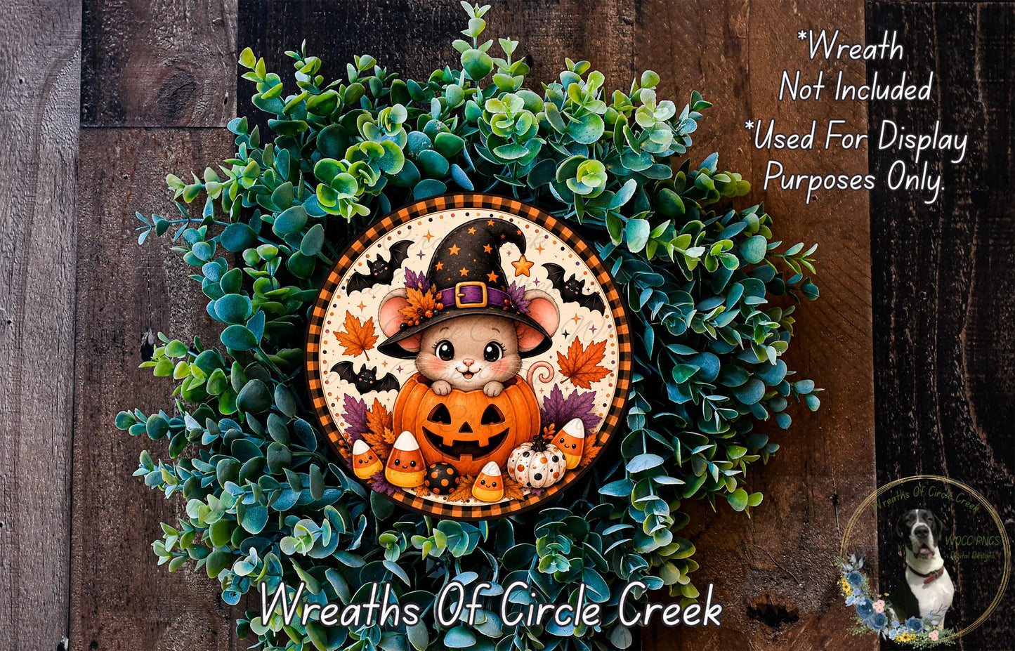 A Halloween-themed wreath featuring a cartoon mouse wearing a witch's hat, surrounded by green foliage and a carved jack-o-lantern.