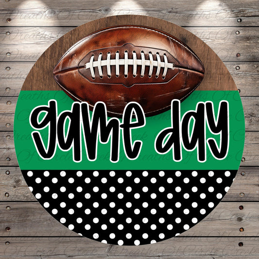 A football is placed on top of a green and black polka dot background with the text "game day" written in a stylized font.