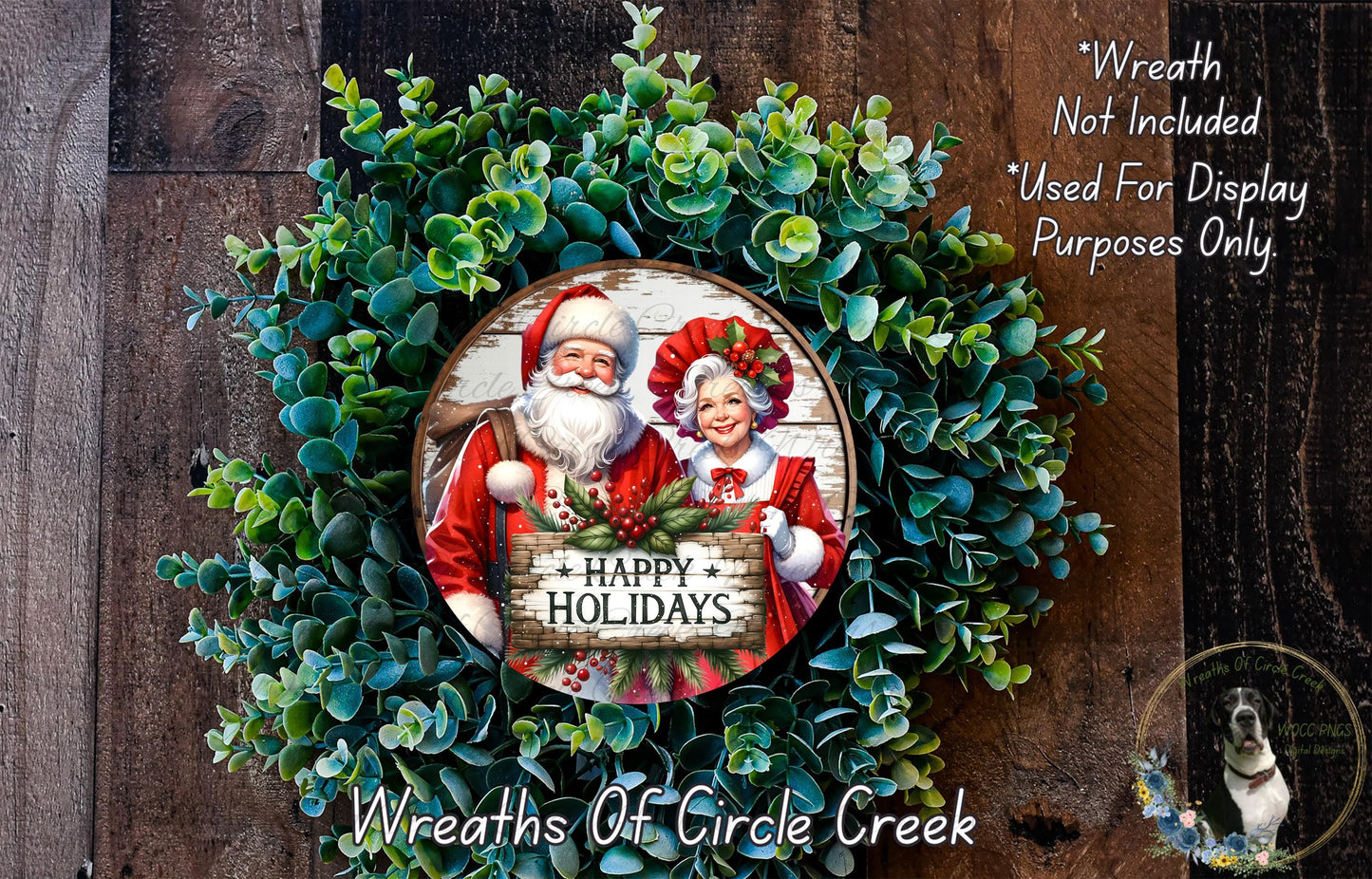 A wreath made of green leaves and featuring a Santa Claus and Granny Claus holding a sign that says "Happy Holidays".
