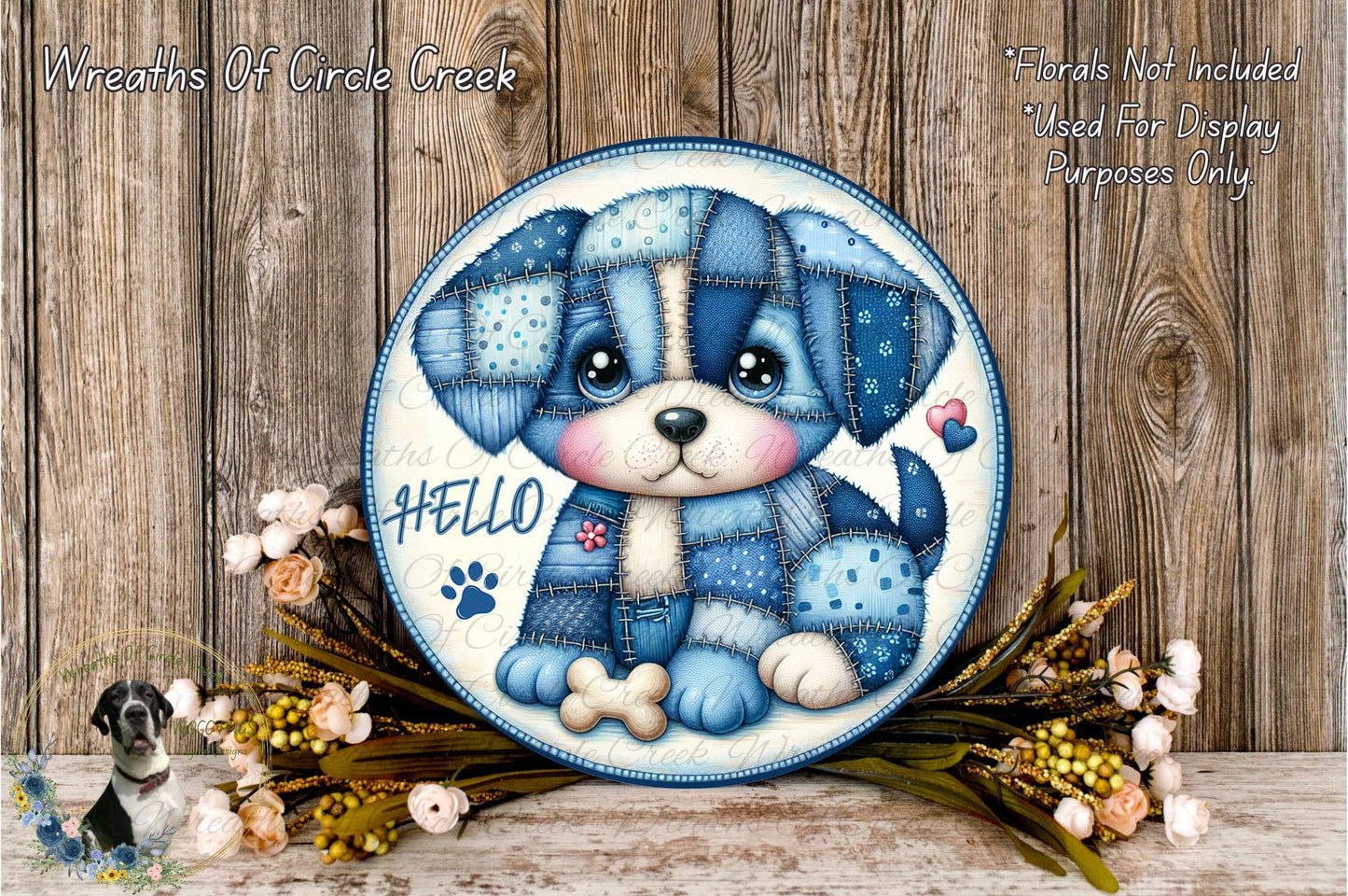 A decorative plate featuring a blue and white dog with a patchwork design, surrounded by flowers and placed on a wooden surface.