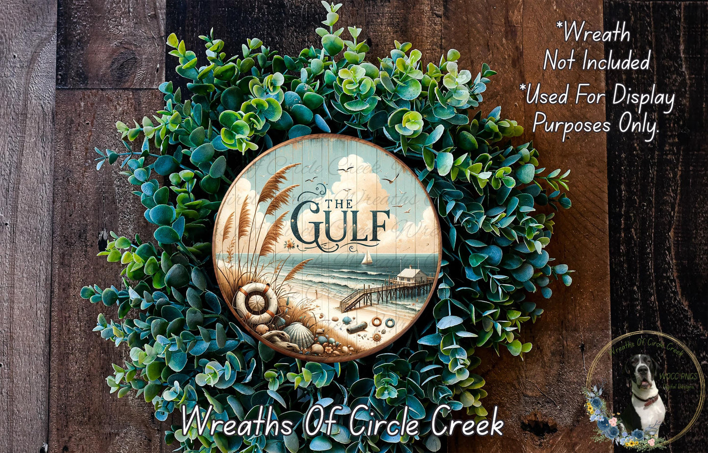 a wreath made of green foliage and a circular wooden plaque with the text "The Gulf" on it, set against a wooden background.