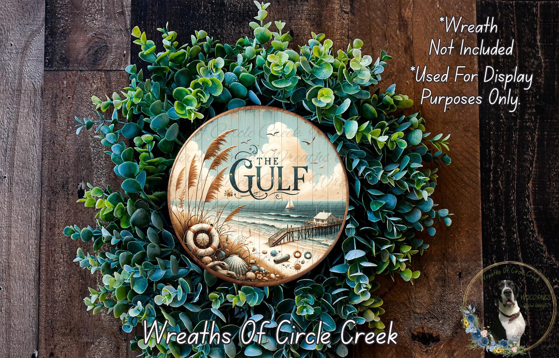 a wreath made of green foliage and a circular wooden plaque with the text "The Gulf" on it, set against a wooden background.