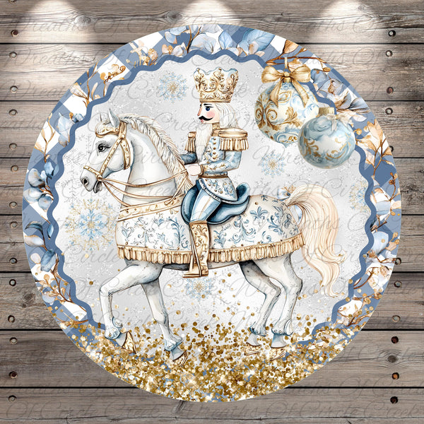 A decorative round plate featuring a white nutcracker figure riding a white horse, with a blue and gold border and a snowy background.