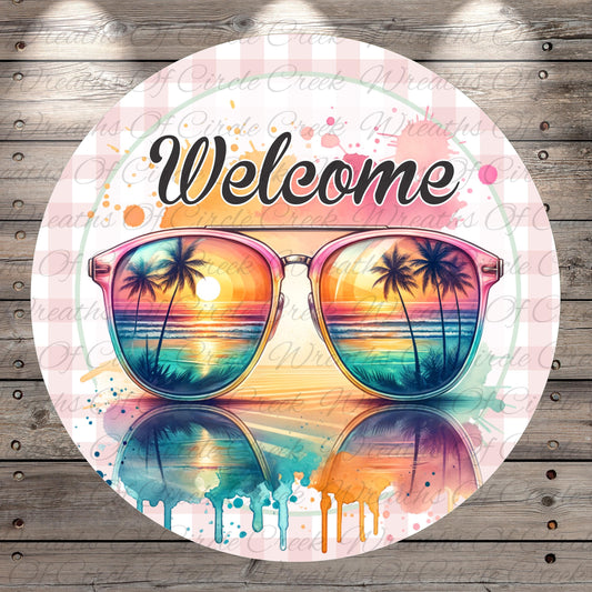 A circular sign with a pair of colorful sunglasses in the center, displaying a tropical beach scene with palm trees and a sunset reflection.