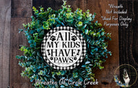 A wreath made of green leaves and a circular sign with the text "All My Kids Have Paws" in the center.