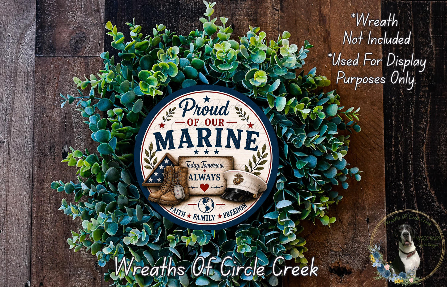 A wreath made of green leaves and a circular sign with the text "Proud of our Marine" and a picture of a Marine boot.
