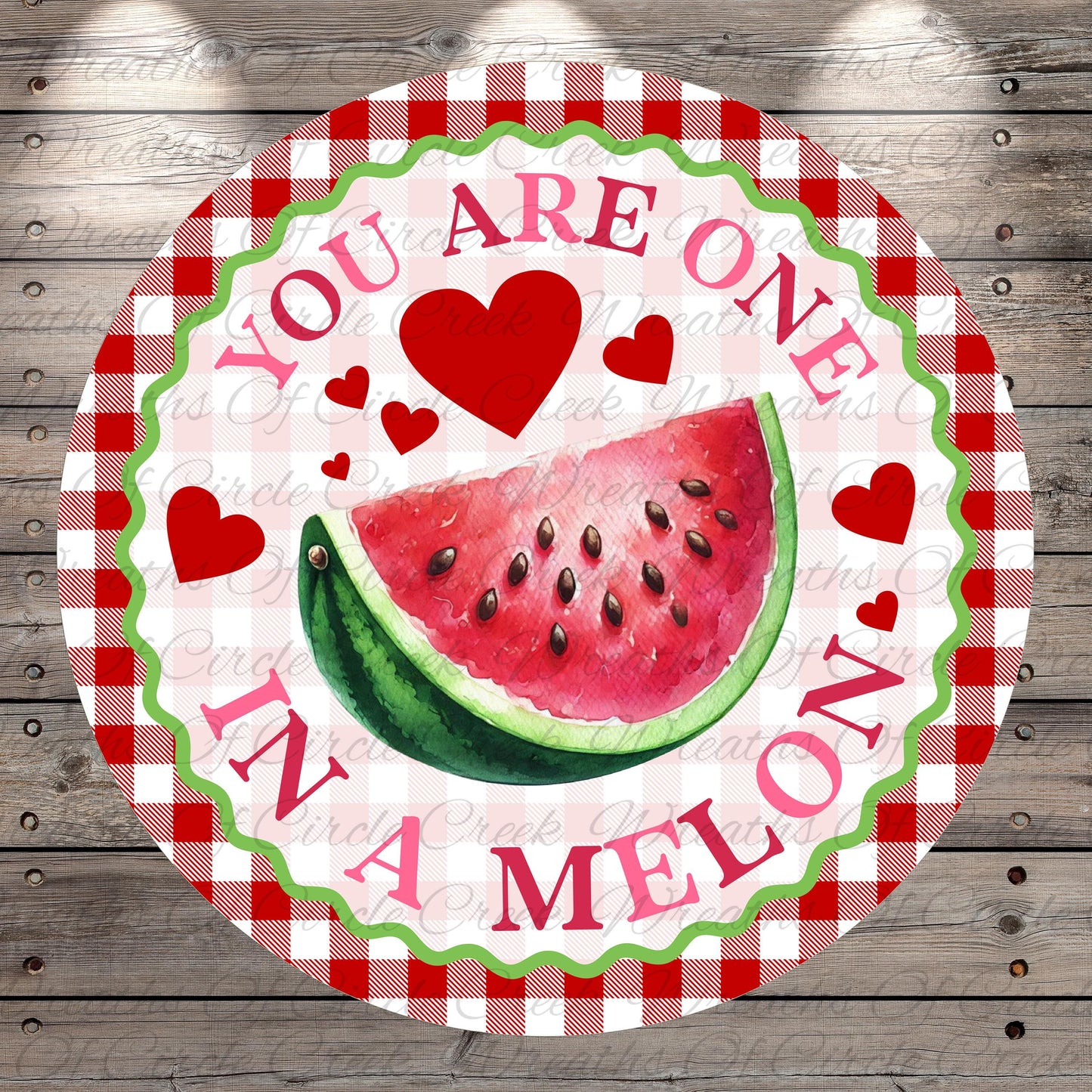 A round sign with a watermelon slice and hearts, surrounded by the text "YOU ARE ONE IN A MELON".