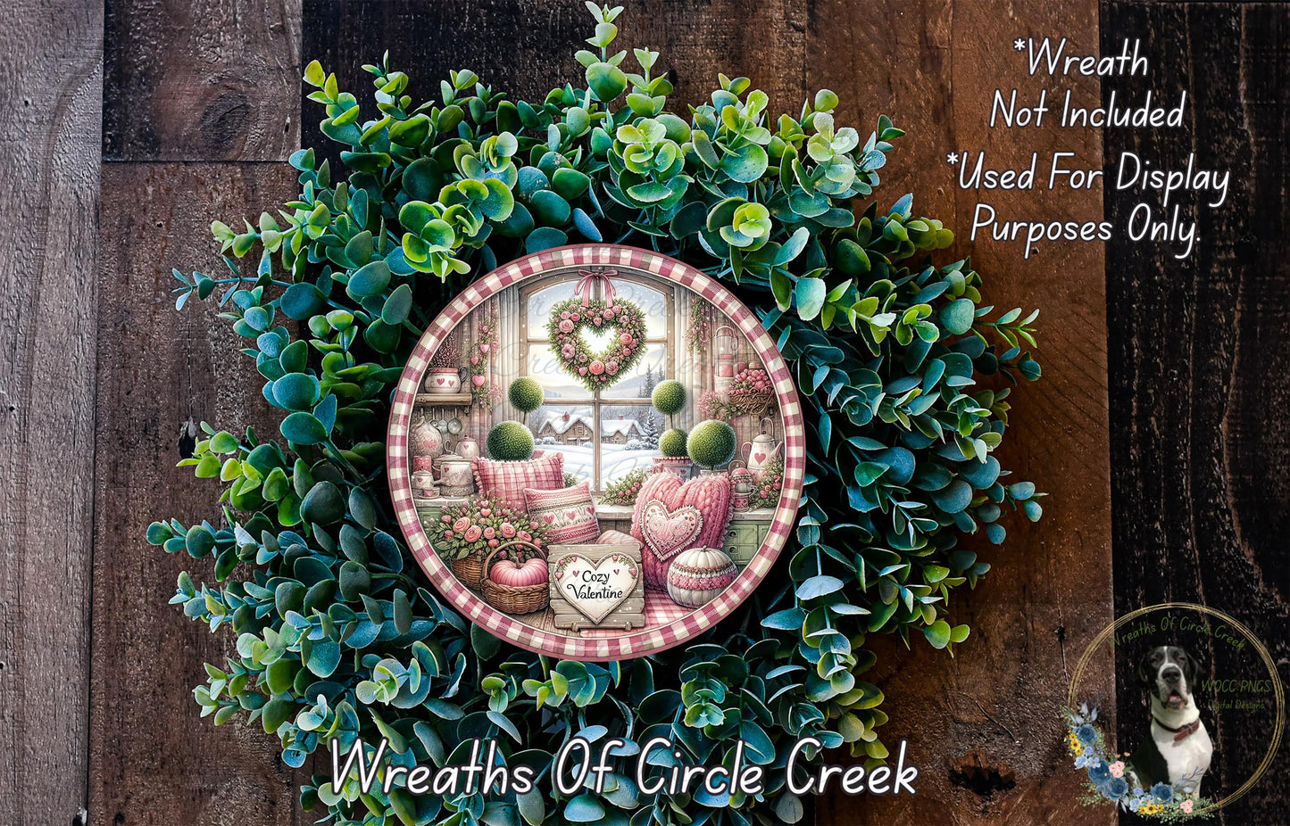 a wreath with a decorative plate containing a scene of a cozy indoor setting, including a window, a heart-shaped decoration, and various other decorative elements.