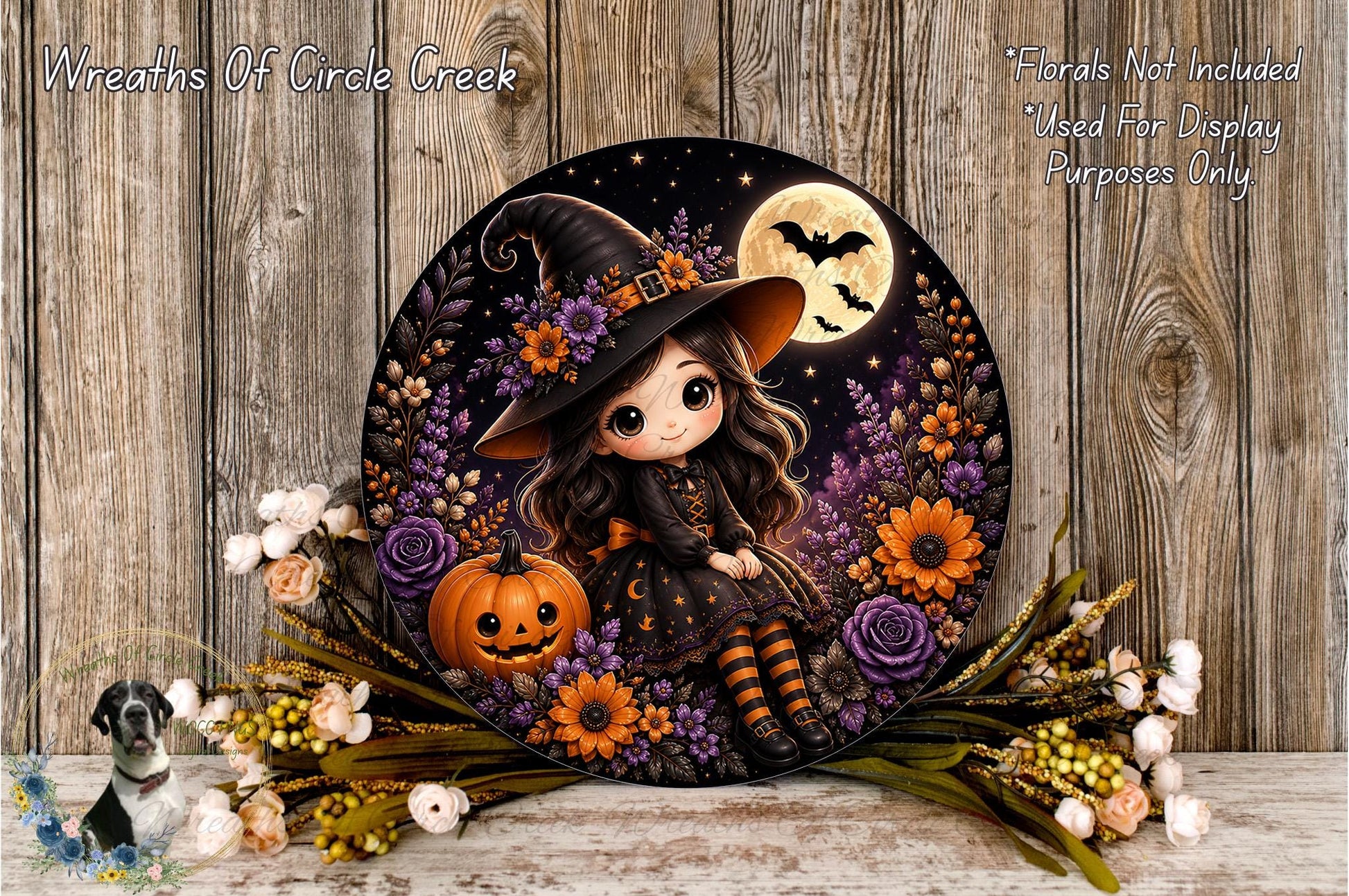A Halloween-themed wreath featuring a young girl dressed as a witch, surrounded by a pumpkin, flowers, and a full moon.