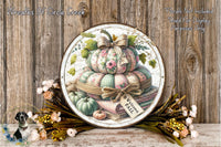 a decorative arrangement of pumpkins and flowers, with a sign that reads "Welcome Fall". The pumpkins are stacked on top of each other, and there are flowers surrounding the arrangement. The wooden background adds a rustic touch to the overall presentation.