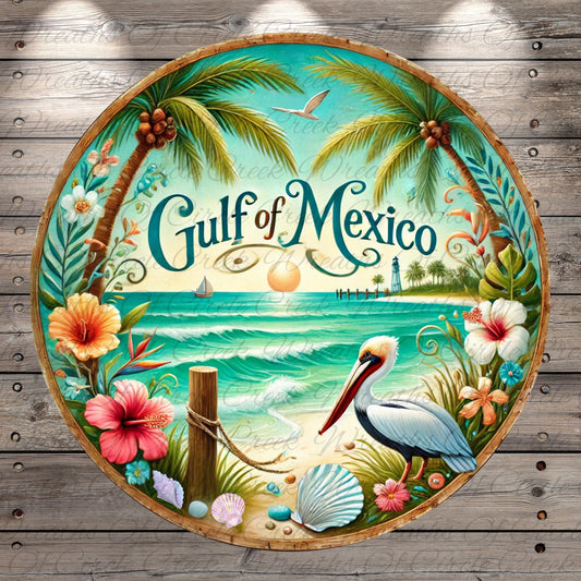 A circular plate with a tropical beach scene, featuring palm trees, a bird, flowers, and a lighthouse. The text "Gulf of Mexico" is prominently displayed in the center of the plate.