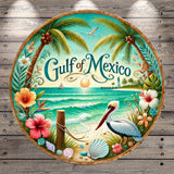A circular plate with a tropical beach scene, featuring palm trees, a bird, flowers, and a lighthouse. The text "Gulf of Mexico" is prominently displayed in the center of the plate.