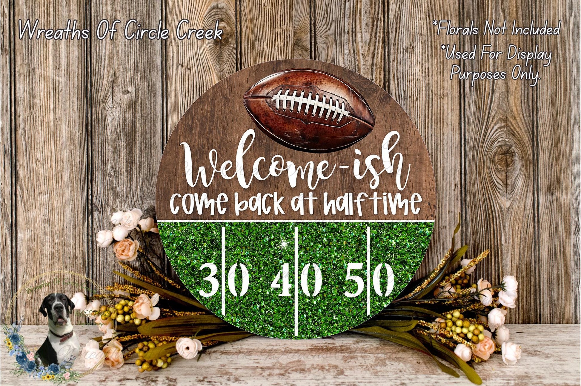 a welcome sign with a football on it, surrounded by a green glittery background and flowers. The sign reads "Welcome-ish Come back at half-time" and has a total of 30 and 40 yards displayed on it.