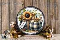 a decorative wreath with a sunflower and two pumpkins, surrounded by flowers and placed on a wooden surface.