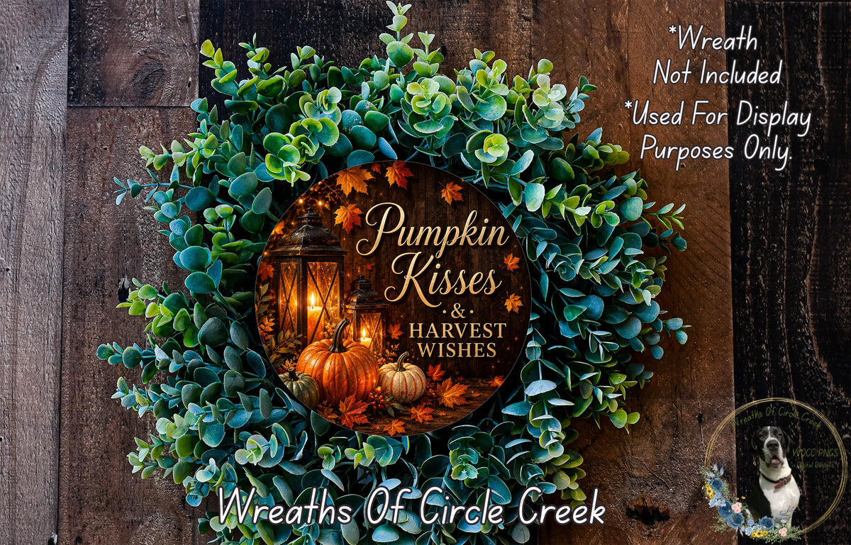 a wreath with a pumpkin and lantern design, surrounded by greenery and autumn leaves, and a message that reads "Pumpkin Kisses & Harvest Wishes".