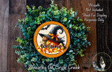 a Halloween-themed wreath with a witch's hat, a pumpkin, and candy corn, surrounded by greenery. The wreath is displayed on a wooden surface, and there is a text overlay that reads "Welcome Wreath Not Included * Used For Display Purposes Only".