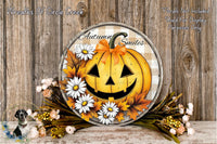 a Halloween-themed wreath with a jack-o-lantern design, surrounded by flowers and autumn leaves. The wreath is displayed on a wooden surface, creating a festive and seasonal atmosphere.