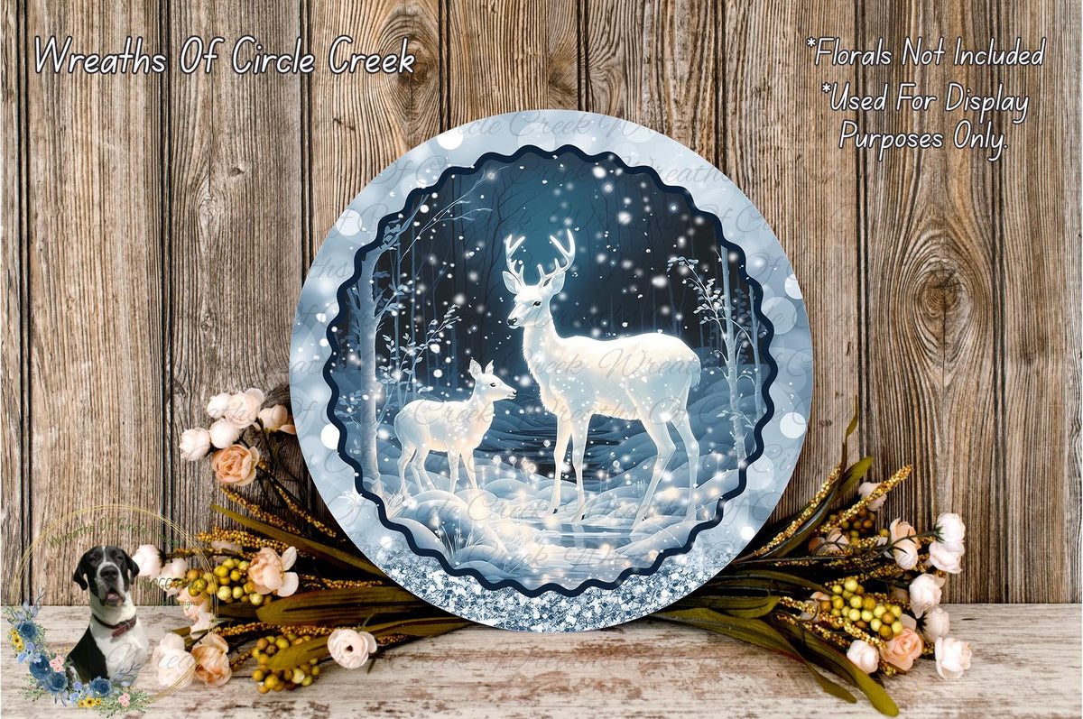 A decorative wreath featuring a snowy winter scene with two deer, surrounded by flowers and greenery, placed on a wooden surface.