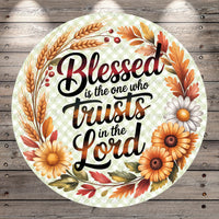 A circular design with a floral border and text that reads "Blessed is the one who trusts in the Lord".